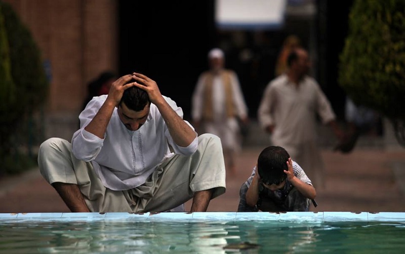 Muslim wash themselves at a fountain in the compound of Jamia Masjid or